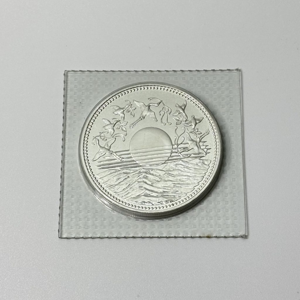 天皇陛下御在位六十年記念1万円銀貨
